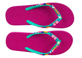 Pair of pink flip-flops with colorful bead embellishments on a white background