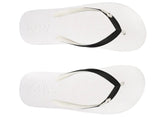 White flip-flops with black straps on a white background