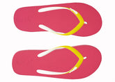 Pair of pink flip-flops with yellow straps on a white background