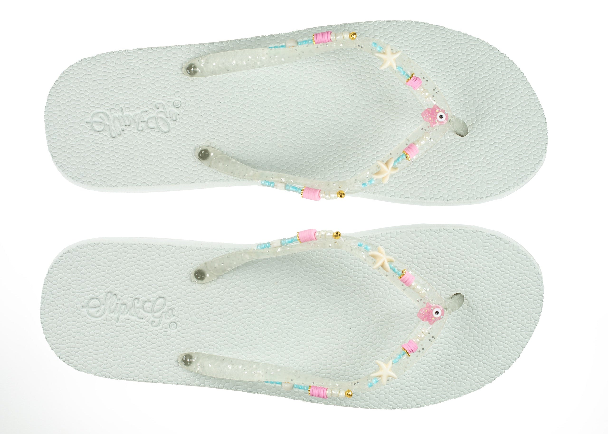 Pair of light blue flip-flops with decorative straps on a white background