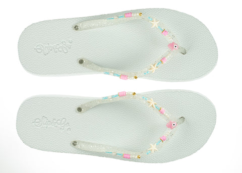 Pair of light blue flip-flops with decorative straps on a white background