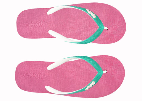 Pair of pink flip-flops with green straps on a white background
