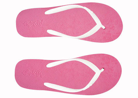Two pink flip-flops with white straps on a white background