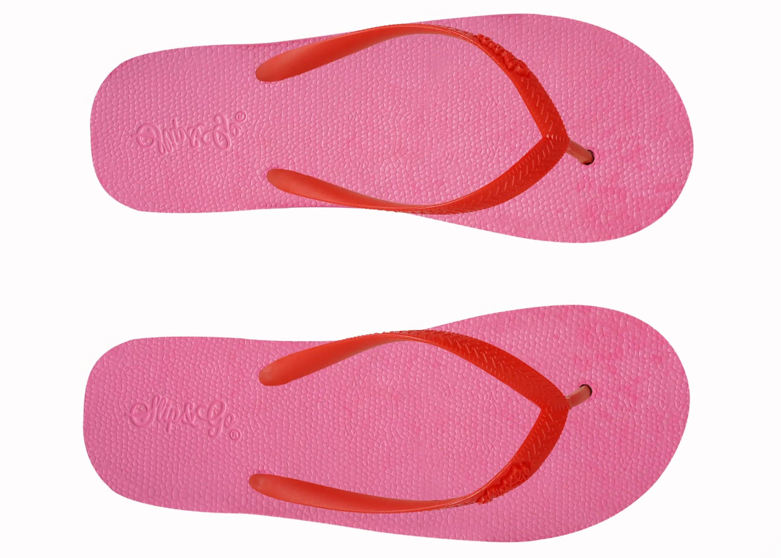 Pair of pink flip-flops with red straps on a white background