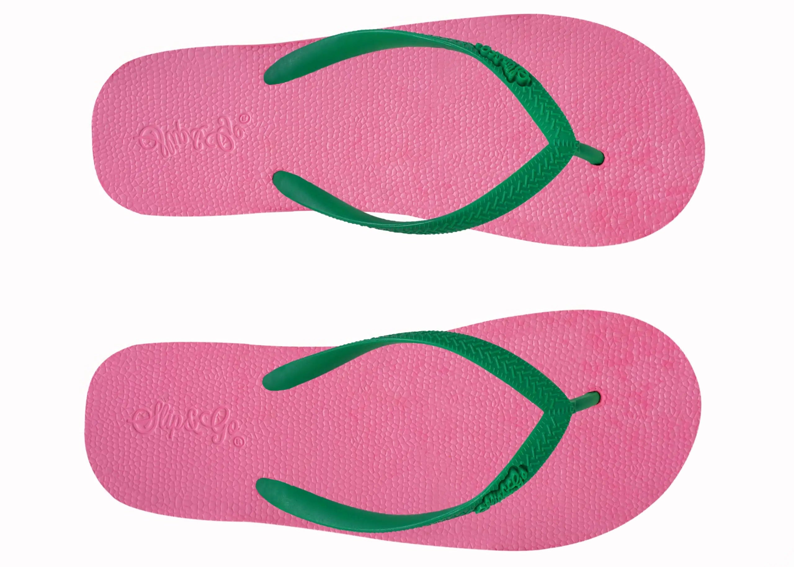 Pink flip-flops with green straps on a white background