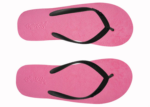 Pink flip-flops with black straps on a white background