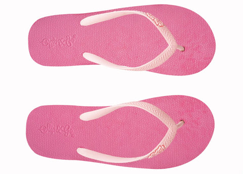 Pair of pink flip-flops with white straps on a white background
