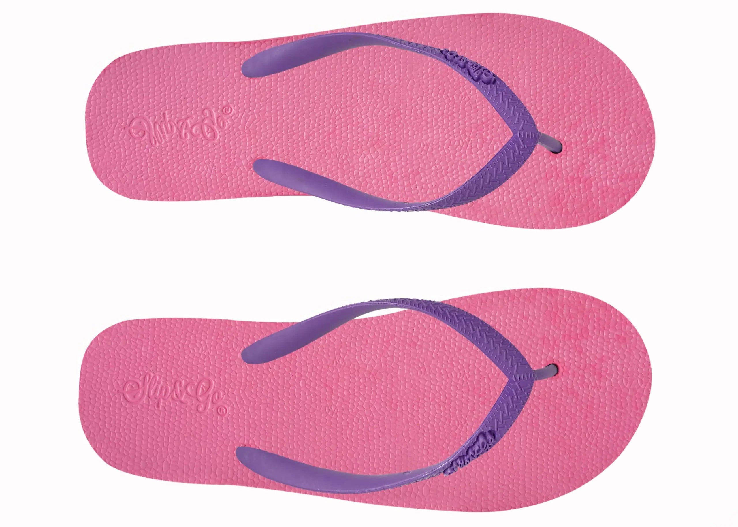 Pair of pink flip-flops with purple straps on a white background