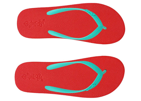 Red flip-flops with turquoise straps on a white background