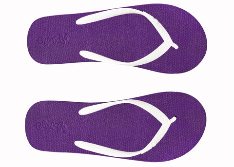 Purple flip-flops with white soles on a white background