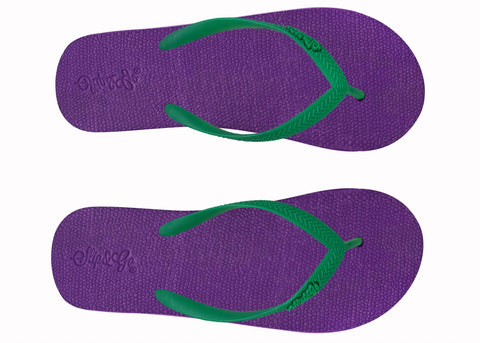 Purple flip-flops with green straps on a white background