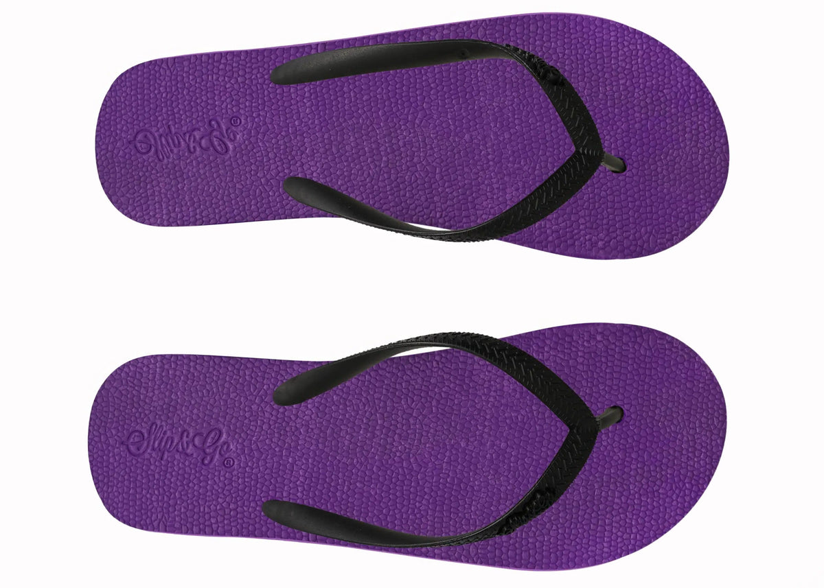 Purple flip-flops with black straps on a white background
