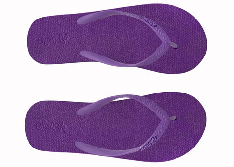 Purple flip-flops on a white background
