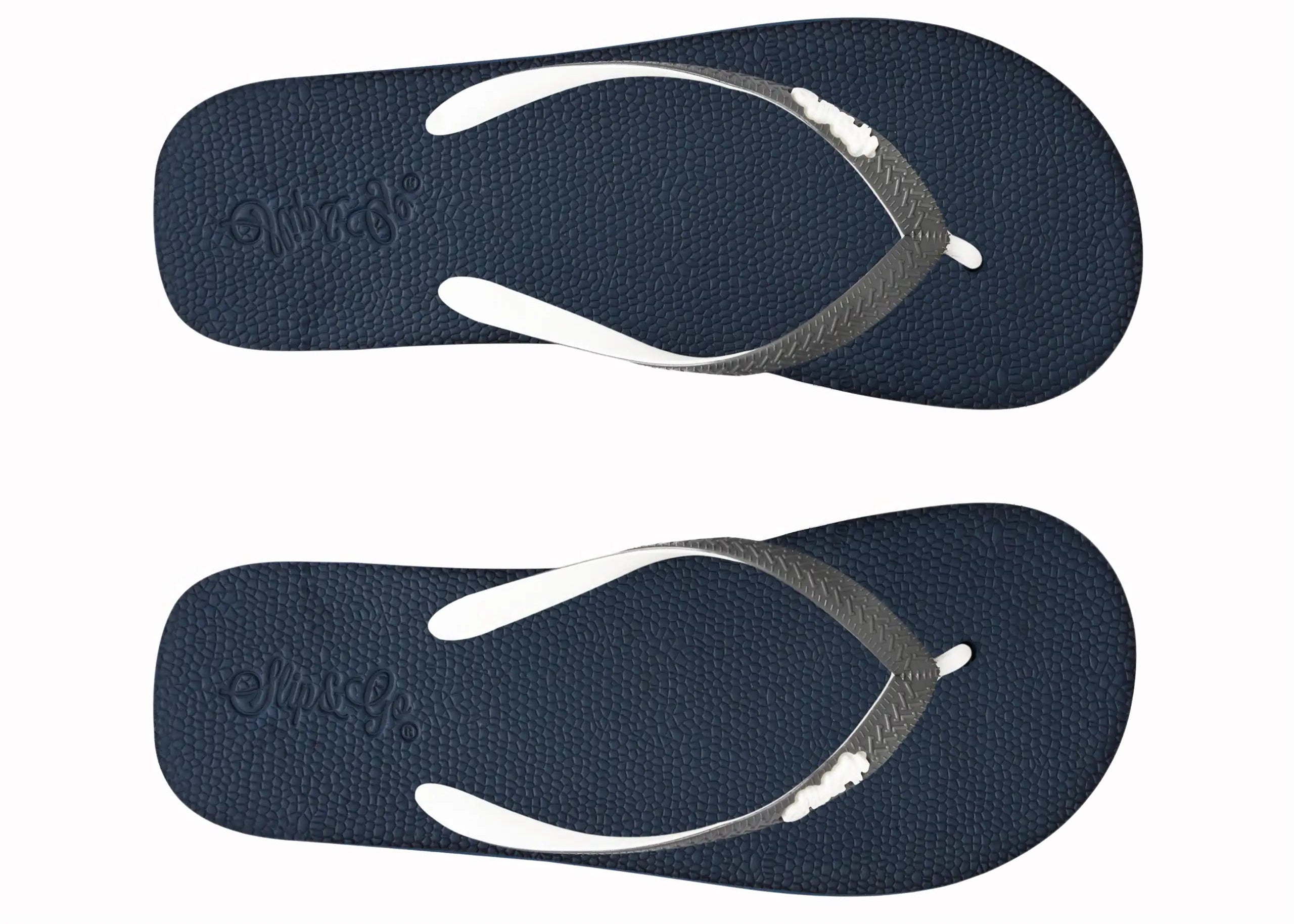 Pair of navy blue flip-flops with white straps on a white background