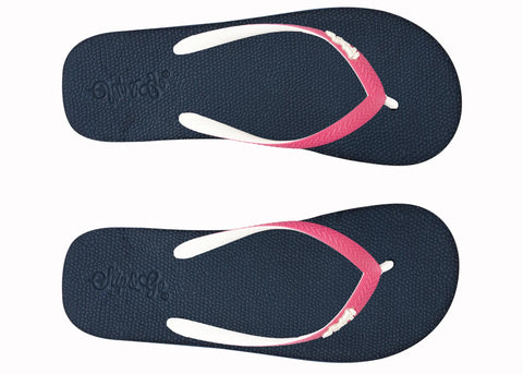 Pair of navy blue flip-flops with pink straps on a white background