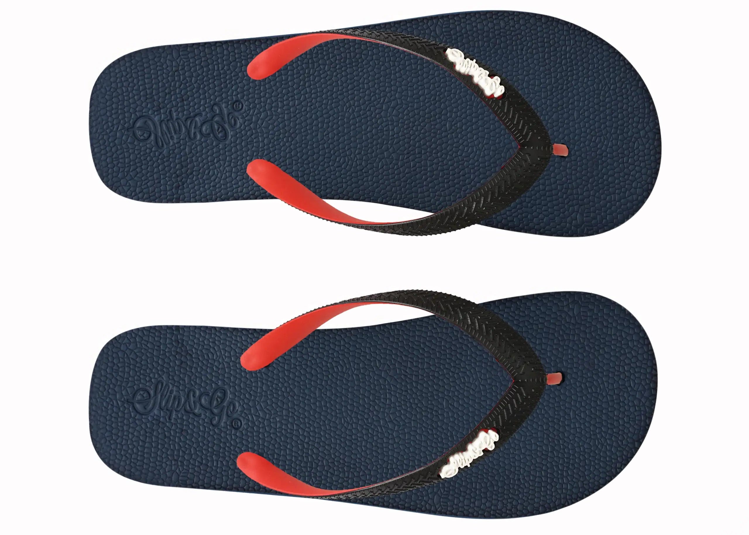 Pair of navy blue flip-flops with red and black straps on a white background