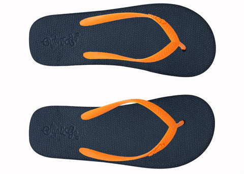 Pair of navy blue flip-flops with orange straps on a white background