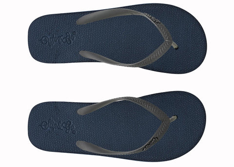 Pair of navy blue flip-flops with gray straps on a white background