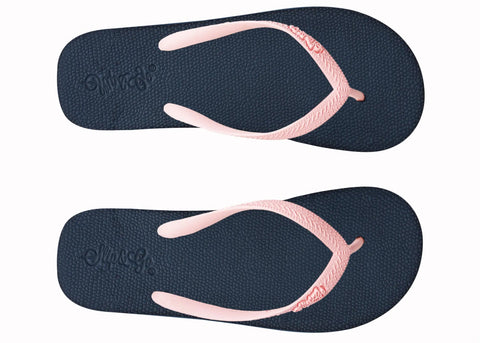Pair of navy blue and pink flip-flops on a white background