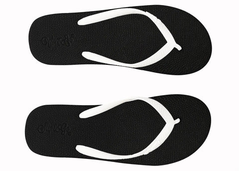 Black flip-flops with white straps on a white background