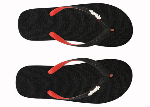 Black flip-flops with red soles and white logo on a white background