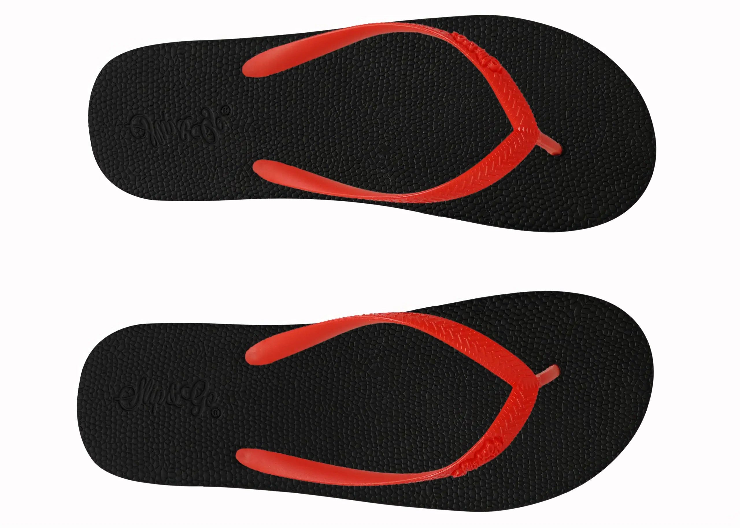 Black flip-flops with red soles on a white background