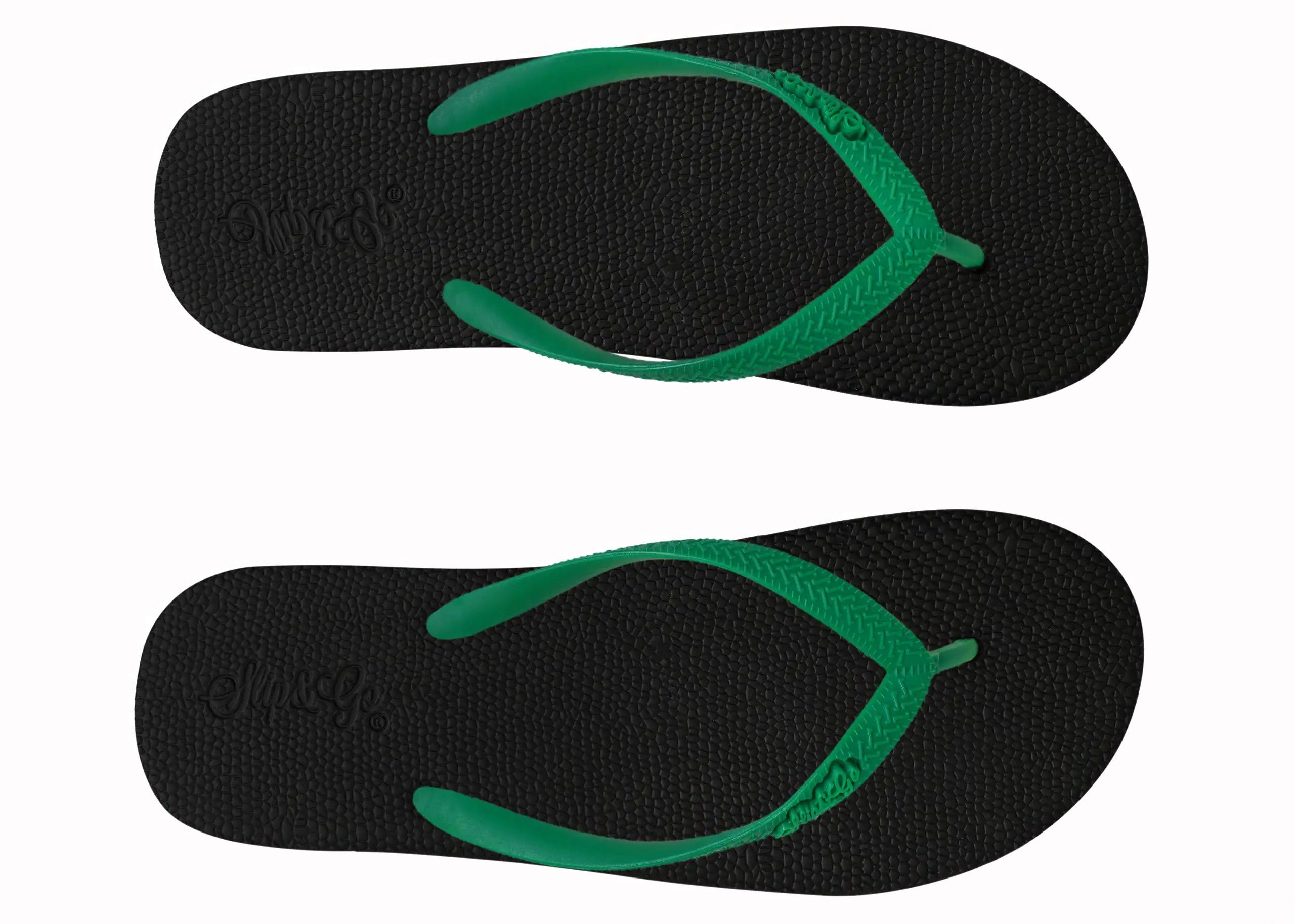 Black flip-flops with green straps on a white background