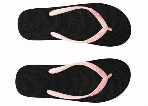 Black flip-flops with pink straps on a white background