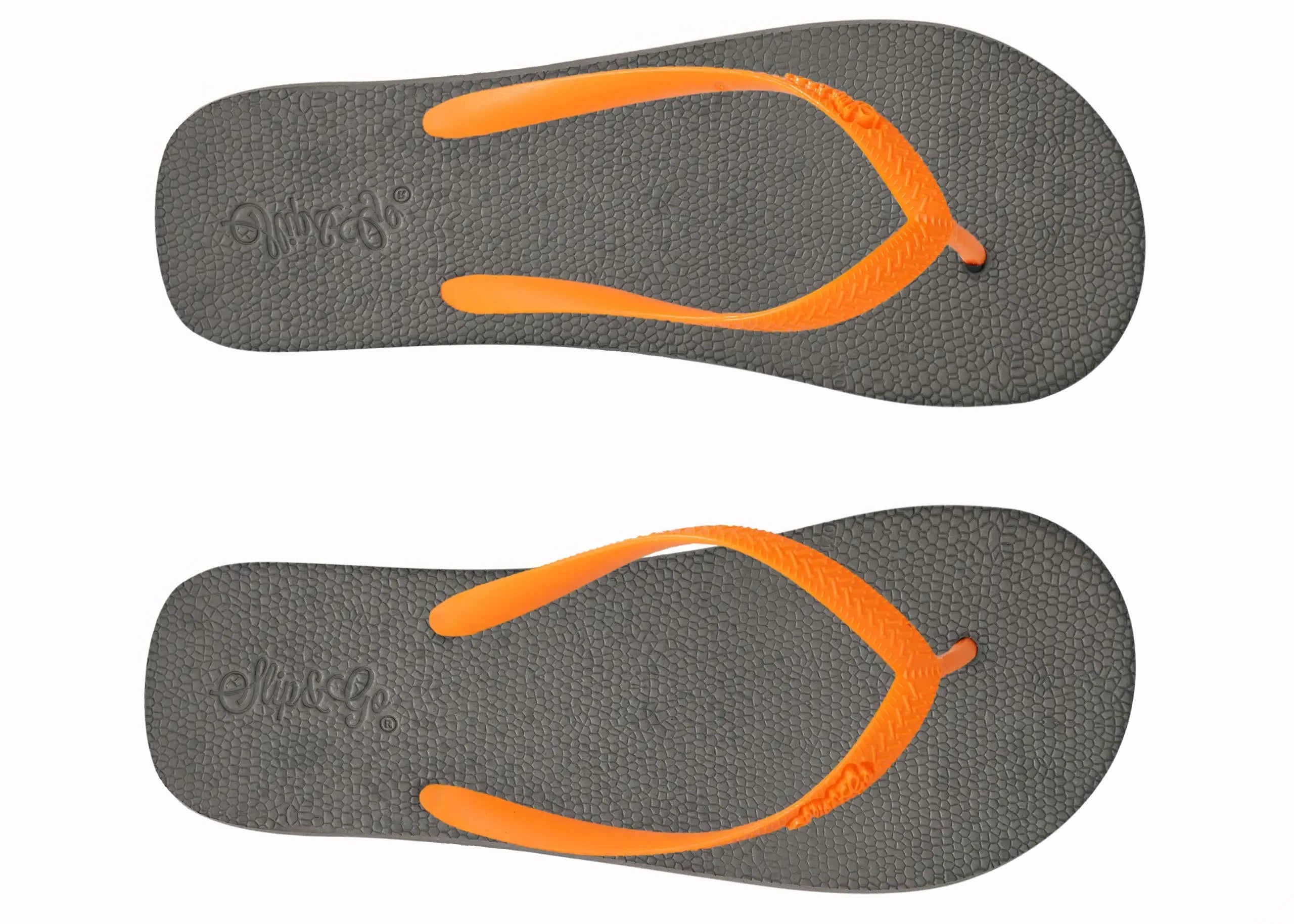 Pair of gray flip-flops with orange straps on a white background