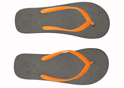 Pair of gray flip-flops with orange straps on a white background