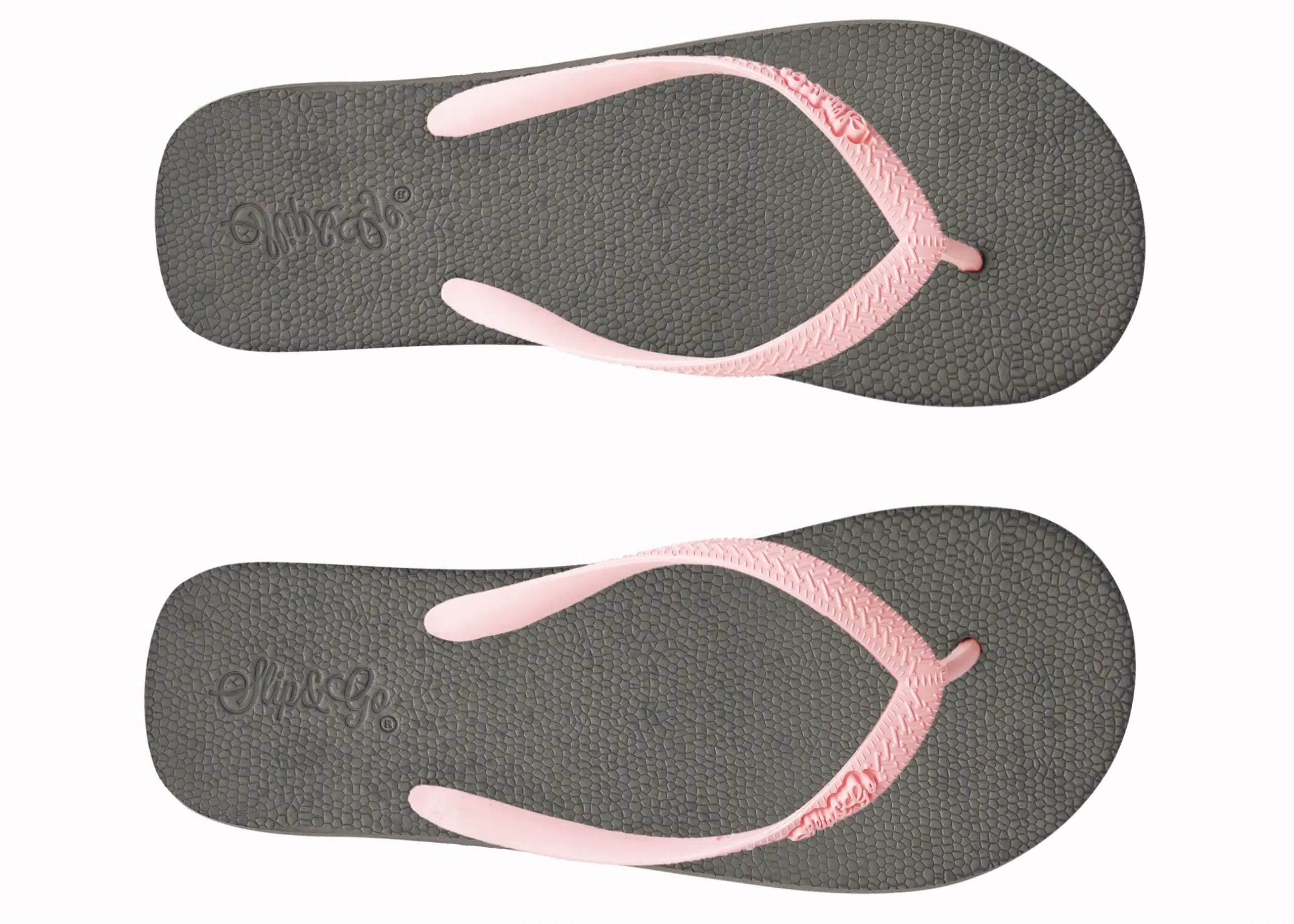 Pair of gray flip-flops with pink straps on a white background