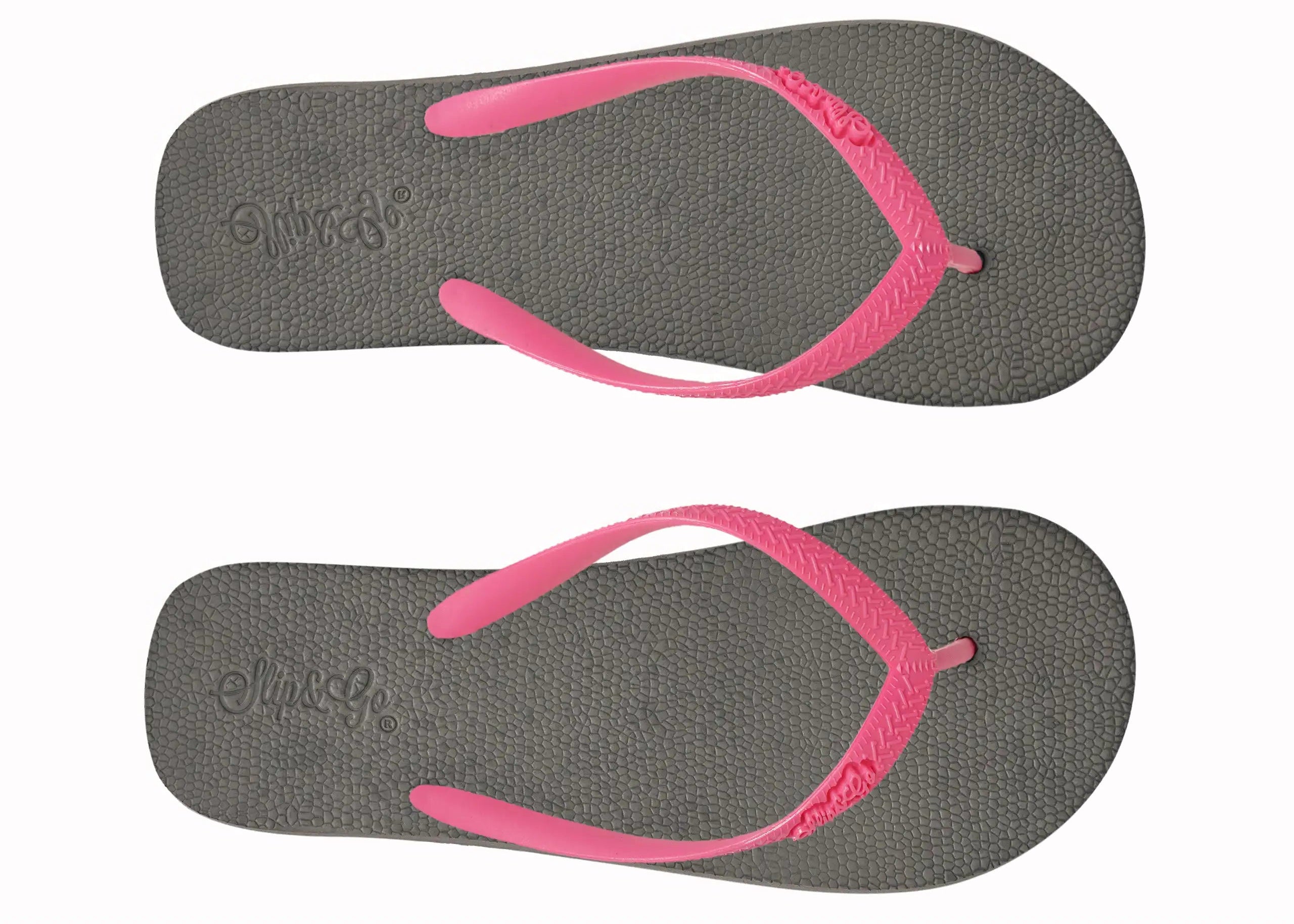 Pair of gray flip-flops with pink straps on a white background