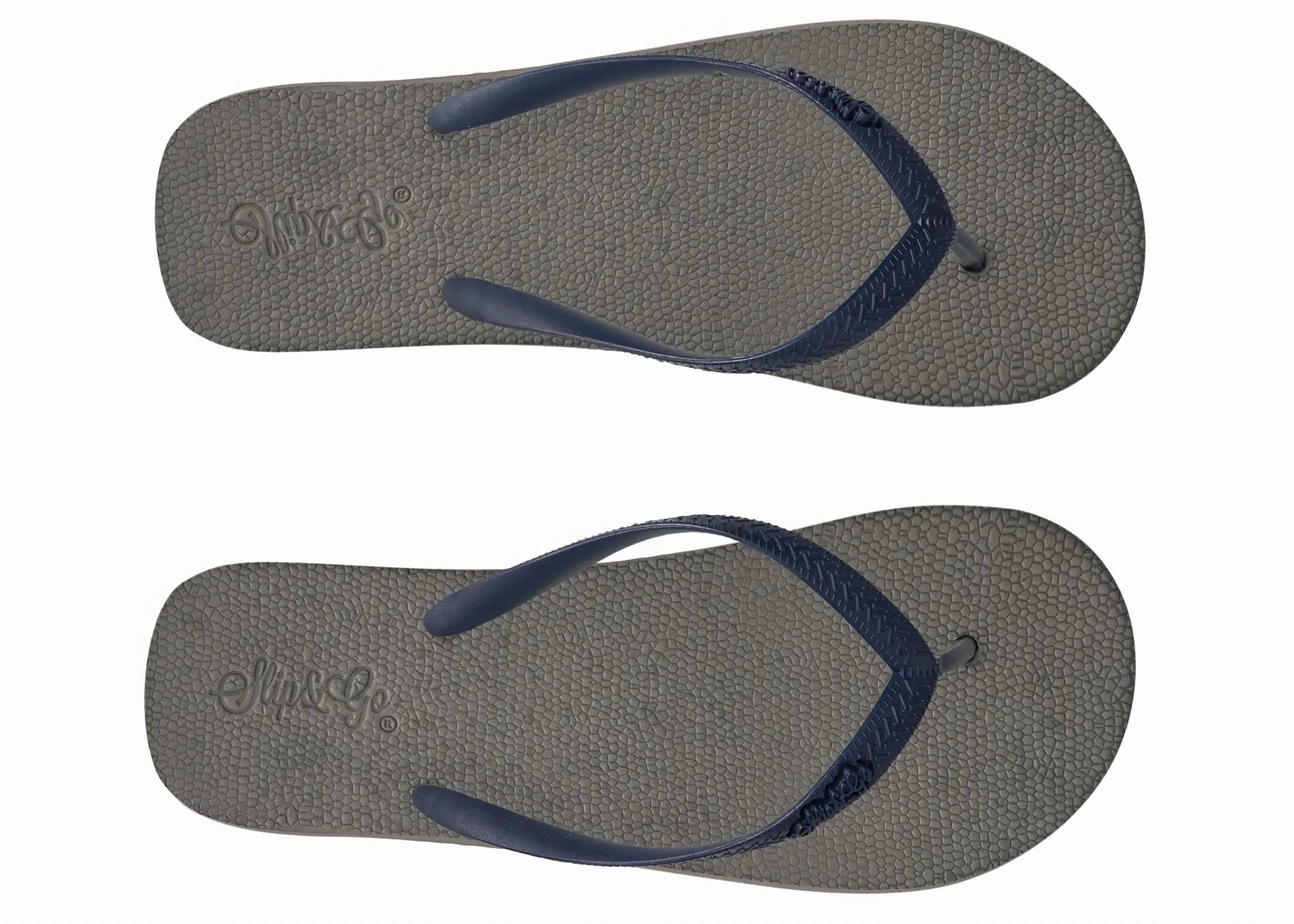 Pair of gray flip-flops with navy straps on a white background