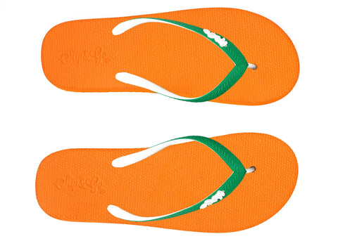 Orange flip-flops with green straps on a white background