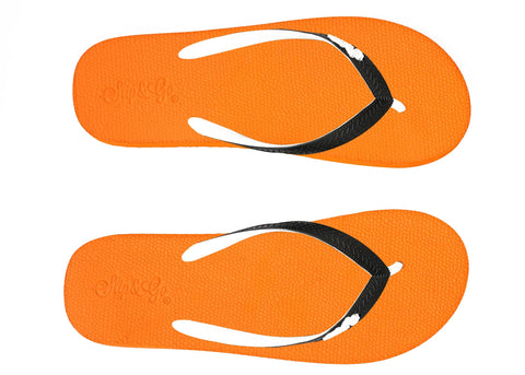 Orange flip-flops with black straps on a white background